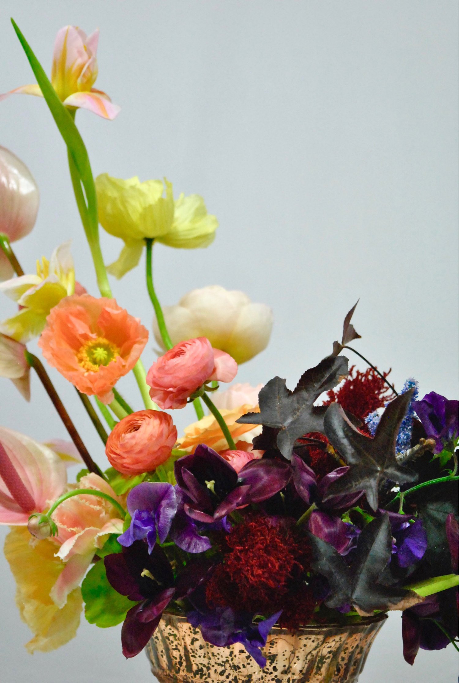 Handpicked seasonal blooms in a footed vessel